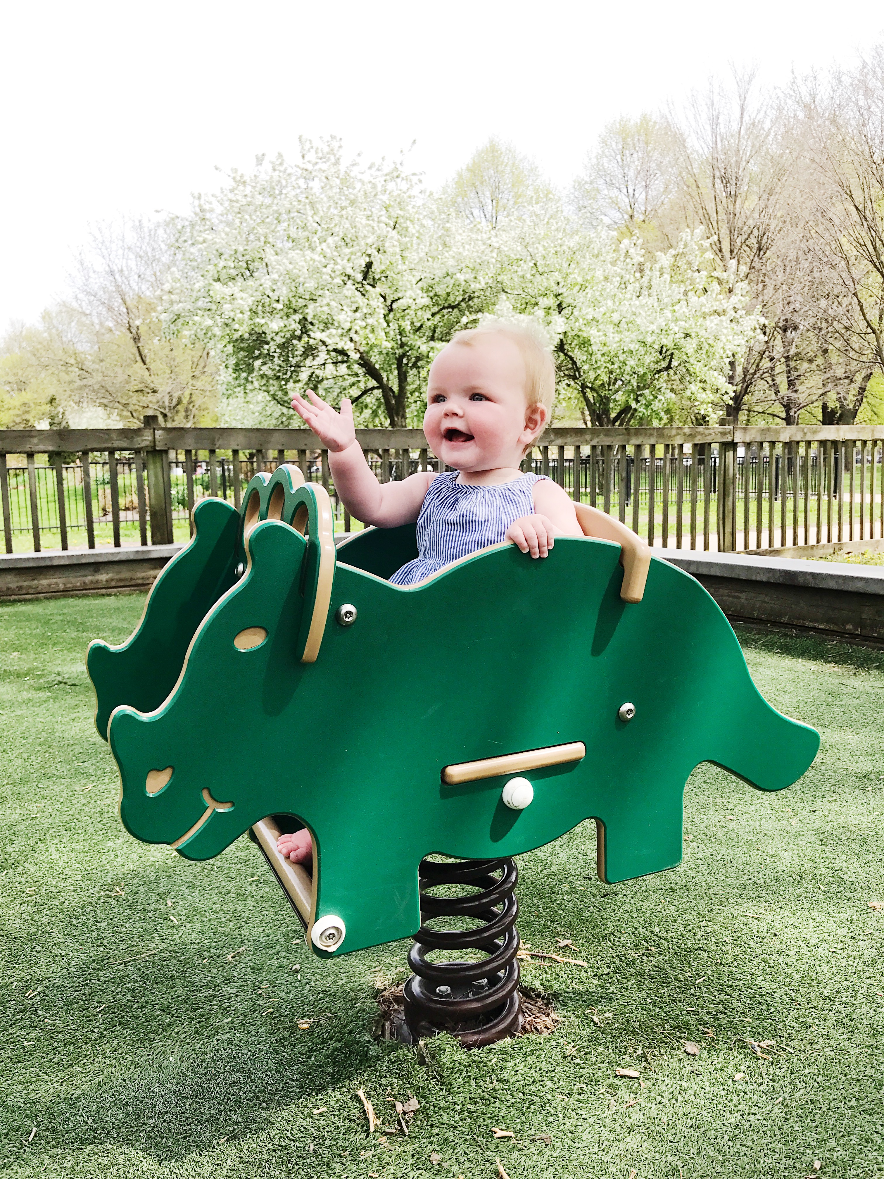 Practicing her princess wave. There's the dinosaur again. We visit him a lot.