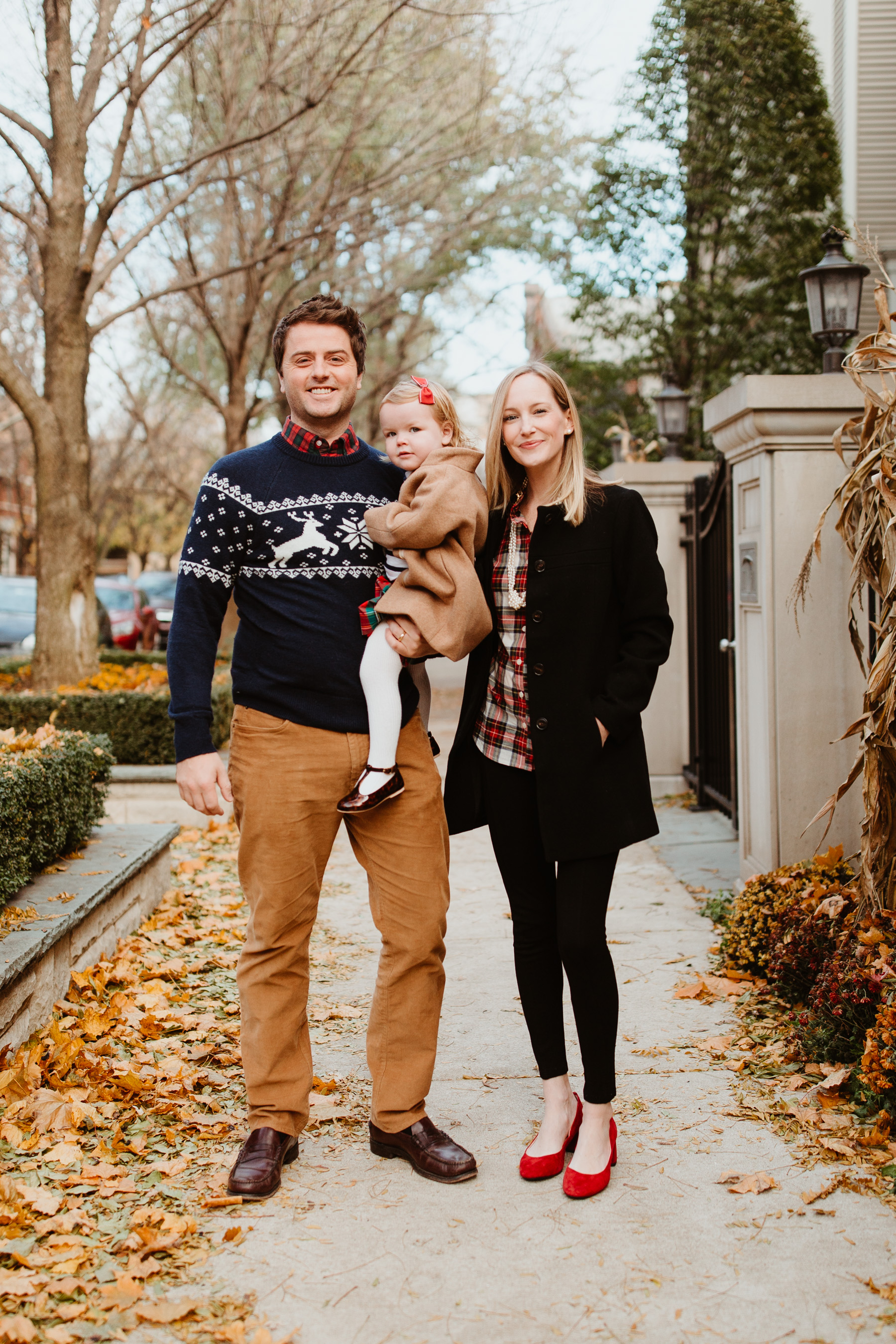 Kelly's Outfit: Tartan Ruffled Shirt, Knotted Pearl Necklace, Bow Coat, Red Block Heel Pumps, Pearl Earrings, Gigi Pants  Mitch's Outfit: Plaid Shirt, Reindeer Sweater, Corduroys, Topcoat  Emma's Outfit: Plaid Skirt, Toddler Cocoon Coat, Striped Turtleneck