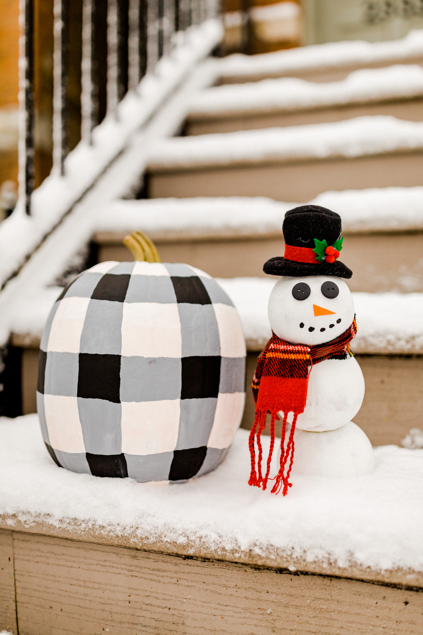 Step Four Buffalo plaid pumpkin: Darken the areas where the vertical and horizontal lines intersect.  Snowman pumpkin: Glue on the buttons, construction paper nose and hat. Tie scarf and paint the mouth! (I removed the head for this stage since it was a bit easier to paint this way, haha.)