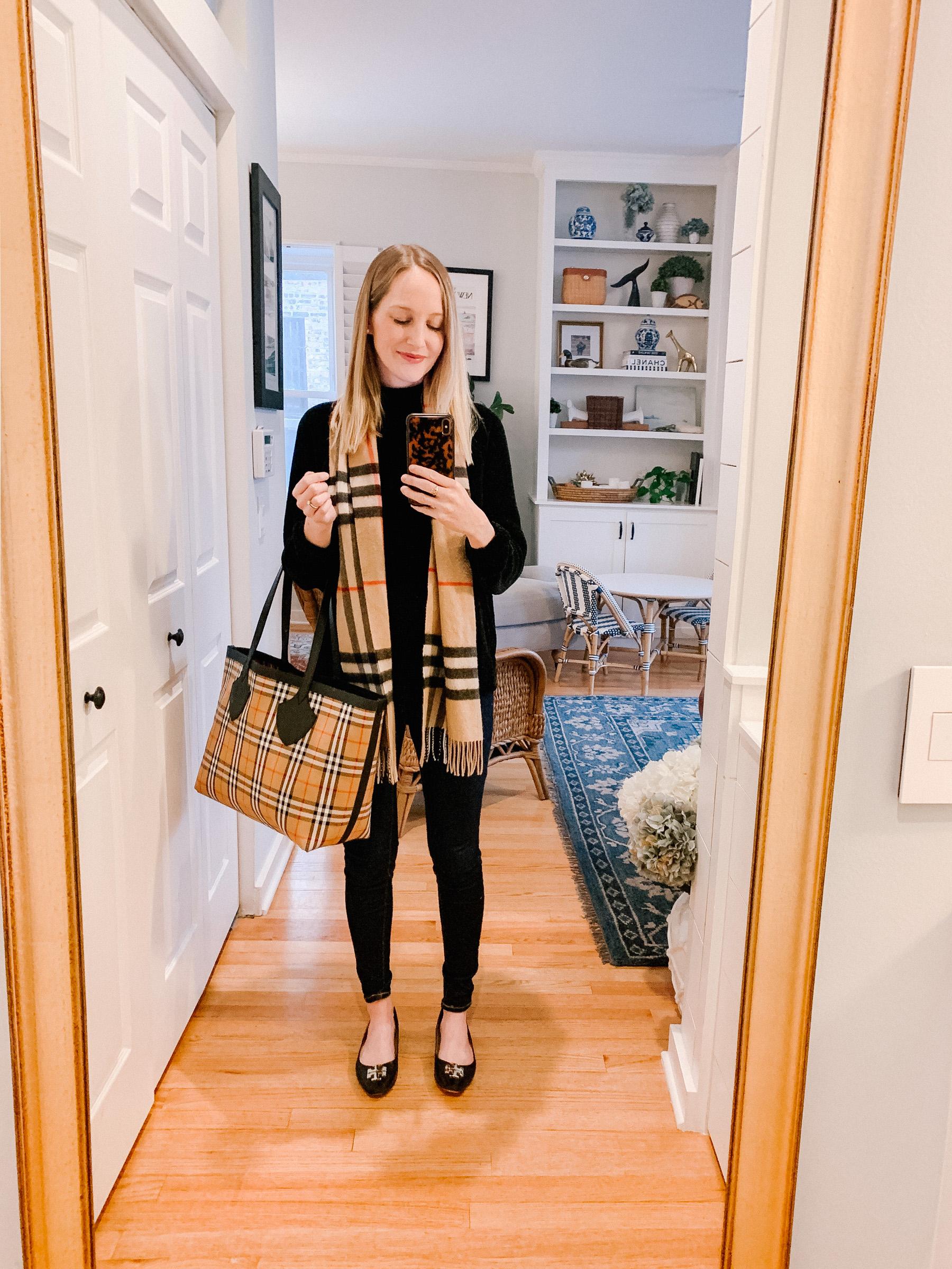 Kelly is wearing a Burberry Scarf, Chenille Sweater and Burberry Tote 