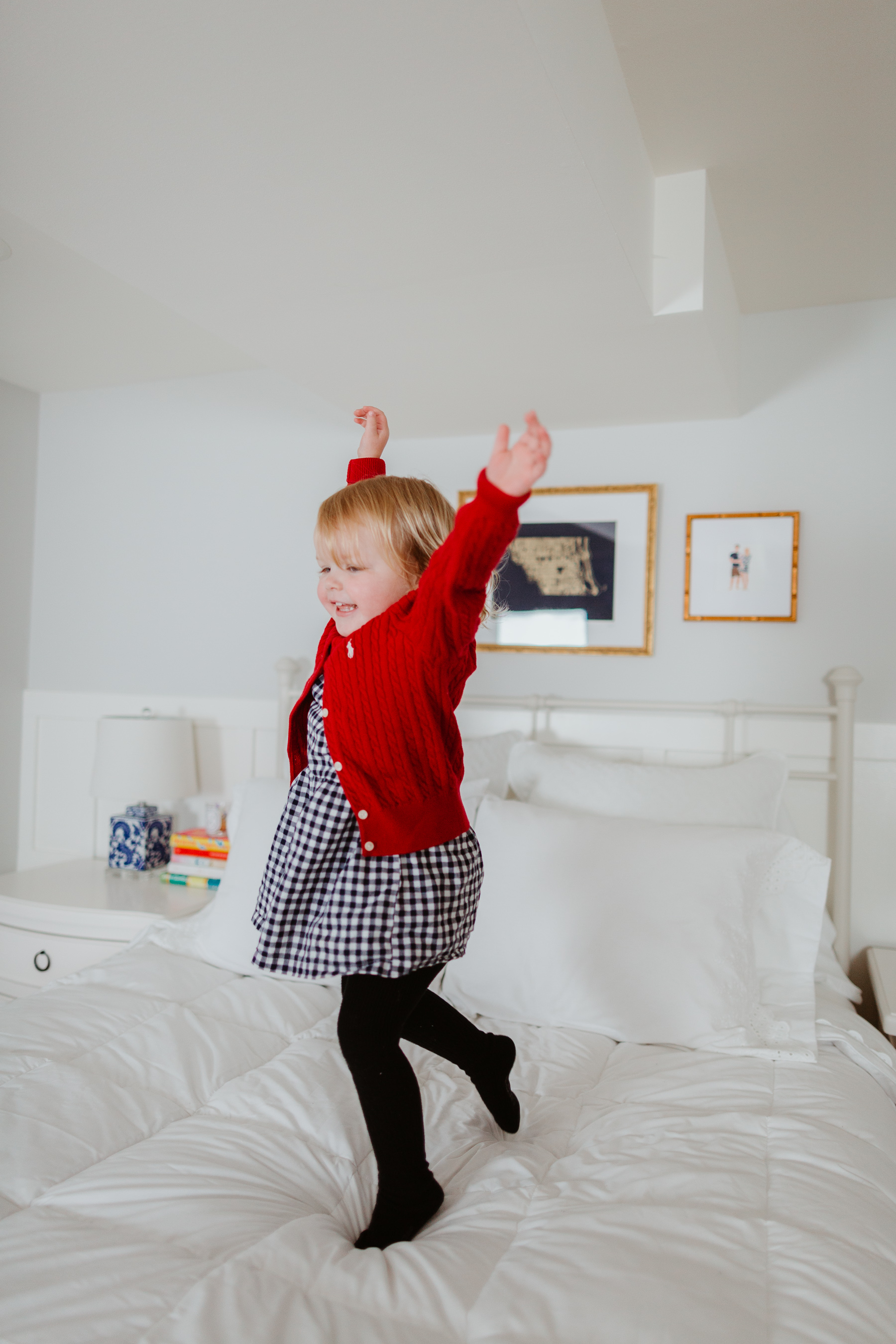 Emma Larkin jumping over the oversized, extra-warm down comforter - The Company Store - White Sale