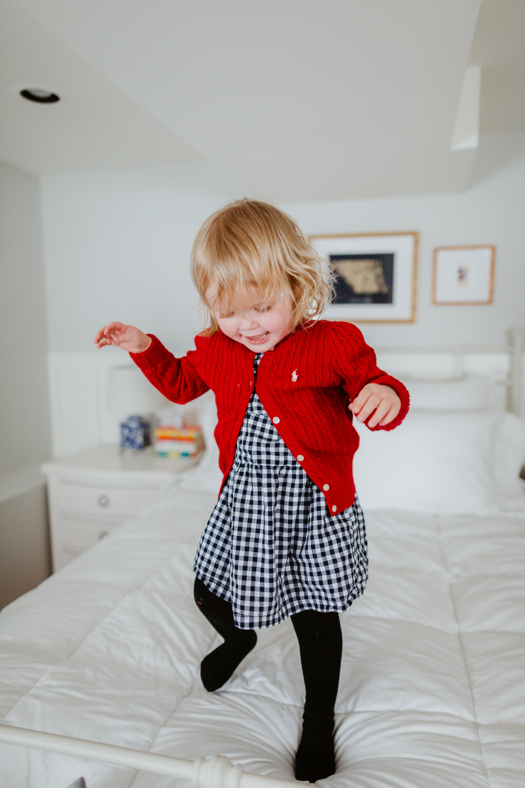 Emma Larkin jumping over  the oversized, extra-warm down comforter - The Company Store - White Sale