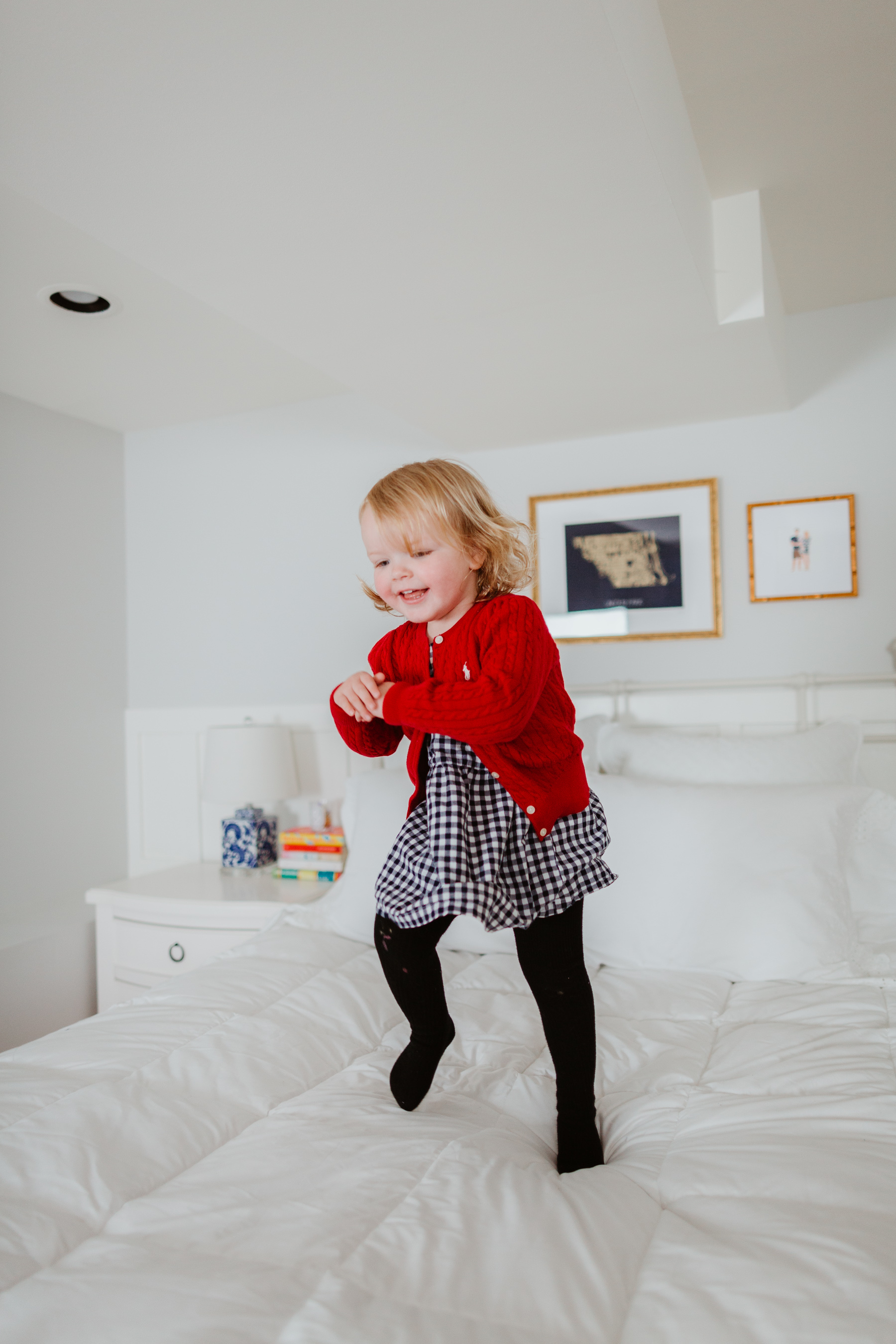 Emma Larkin jumping over the oversized, extra-warm down comforter - The Company Store - White Sale