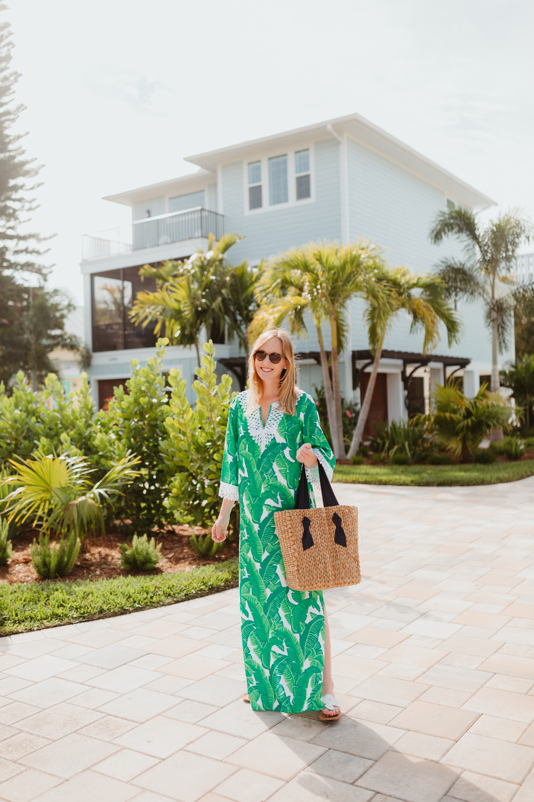 Kelly is wearing a Sail to Sable Banana Leaf Palm Dress / Jack Rogers / Pamela Munson Woven Tote 