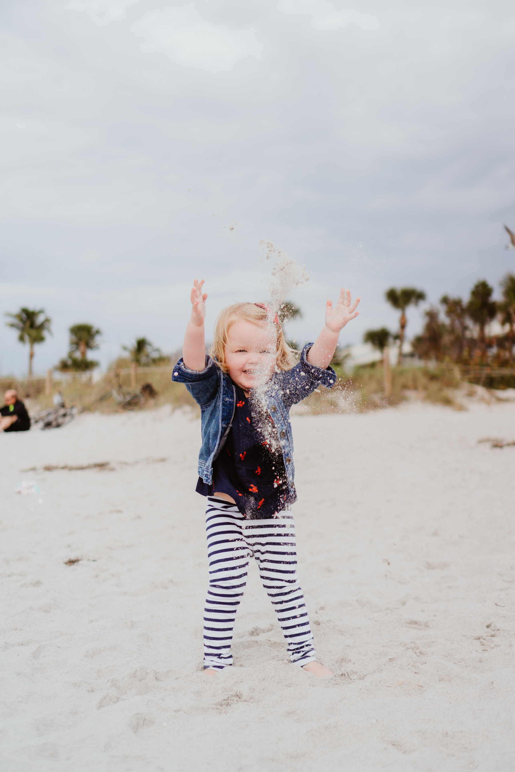 toddler playing at the beach