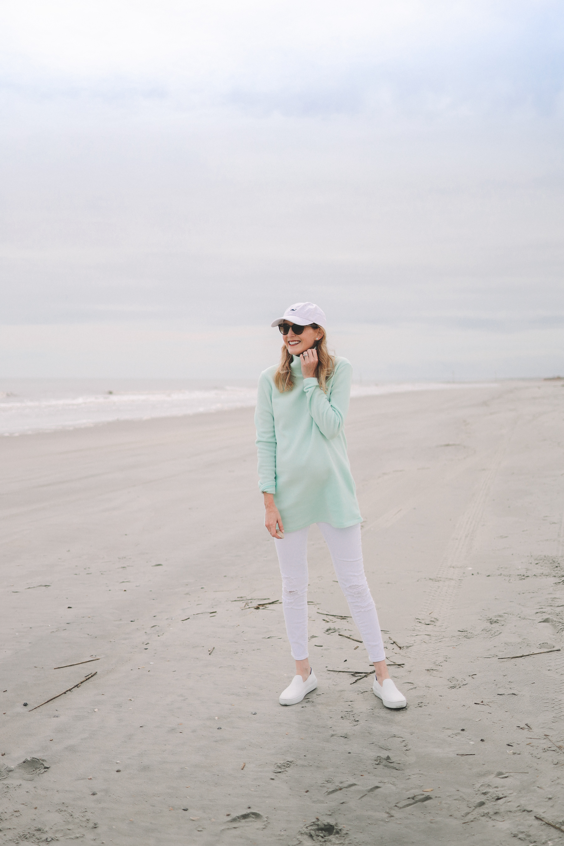 Kelly Larkin’s outfit: Dudley Stephens Cobble Hill Turtleneck / J Brand Maternity Ankle Jeans / Rothy’s Machine-Washable Sneakers / Vineyard Vines Hat