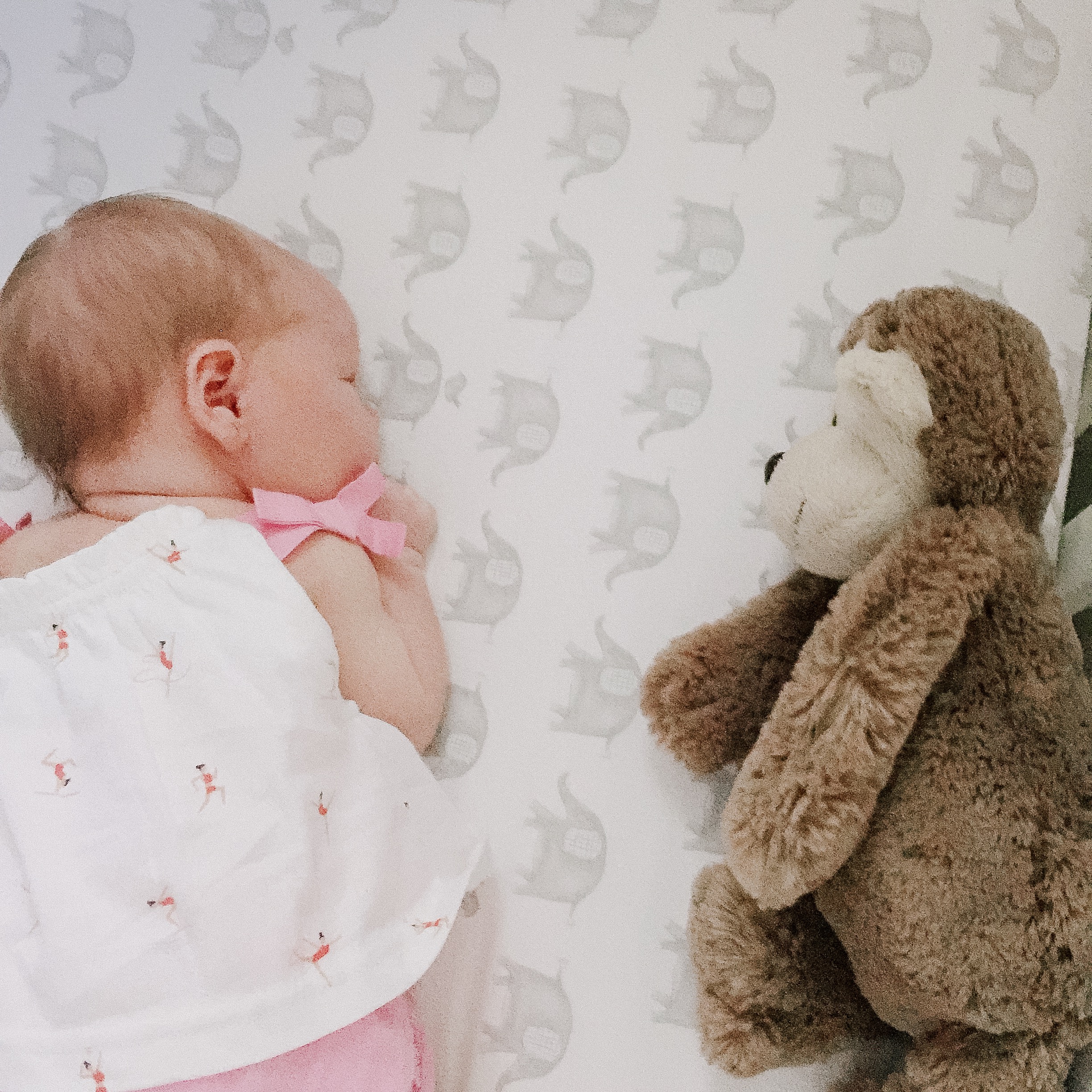 Baby Emma sleeping with a monkey toy