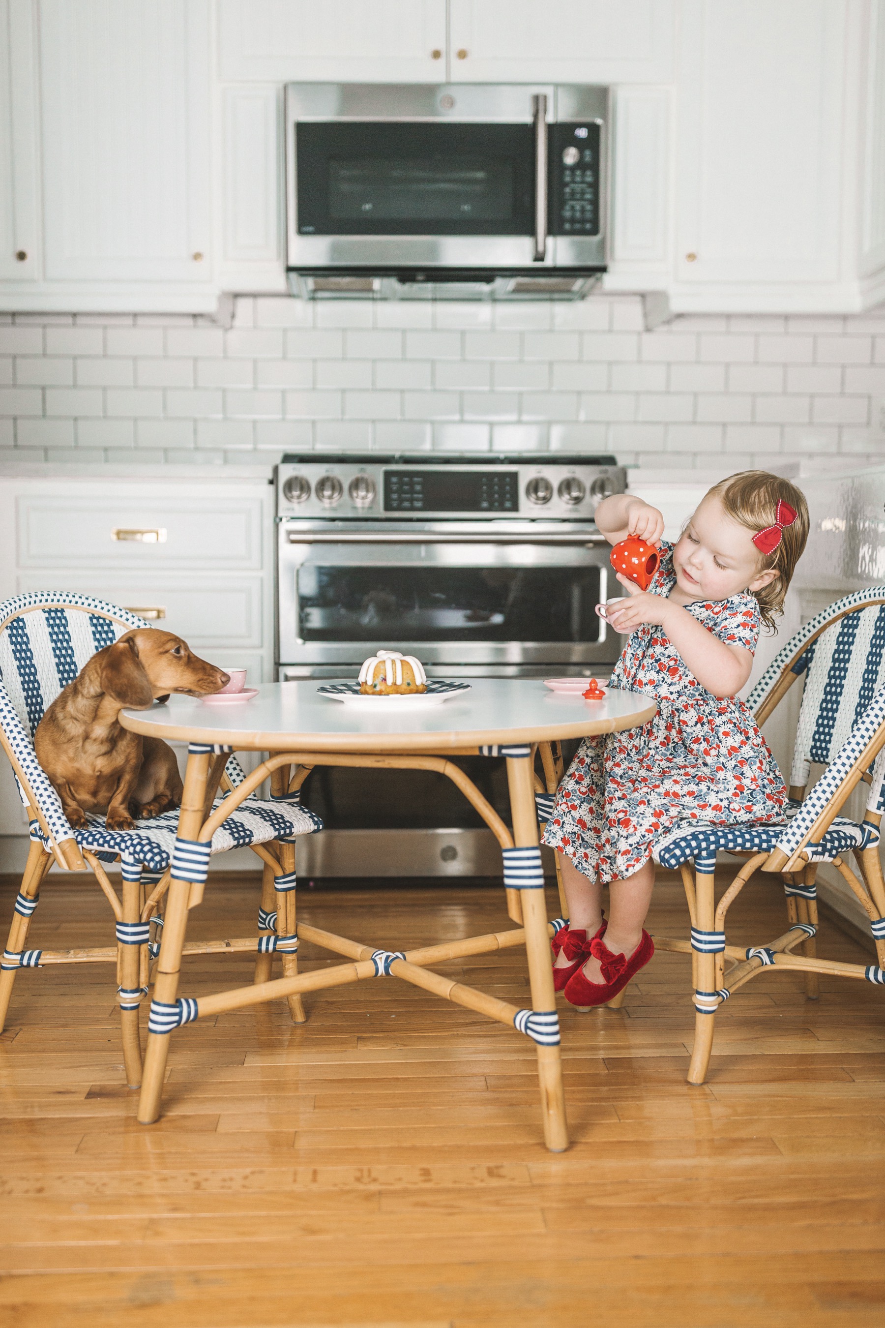 Picture details: Serena & Lily Riviera Kids' Table and Chairs c/o / Old Gap Kids Bow Flats / Newer Ralph Lauren Dress 