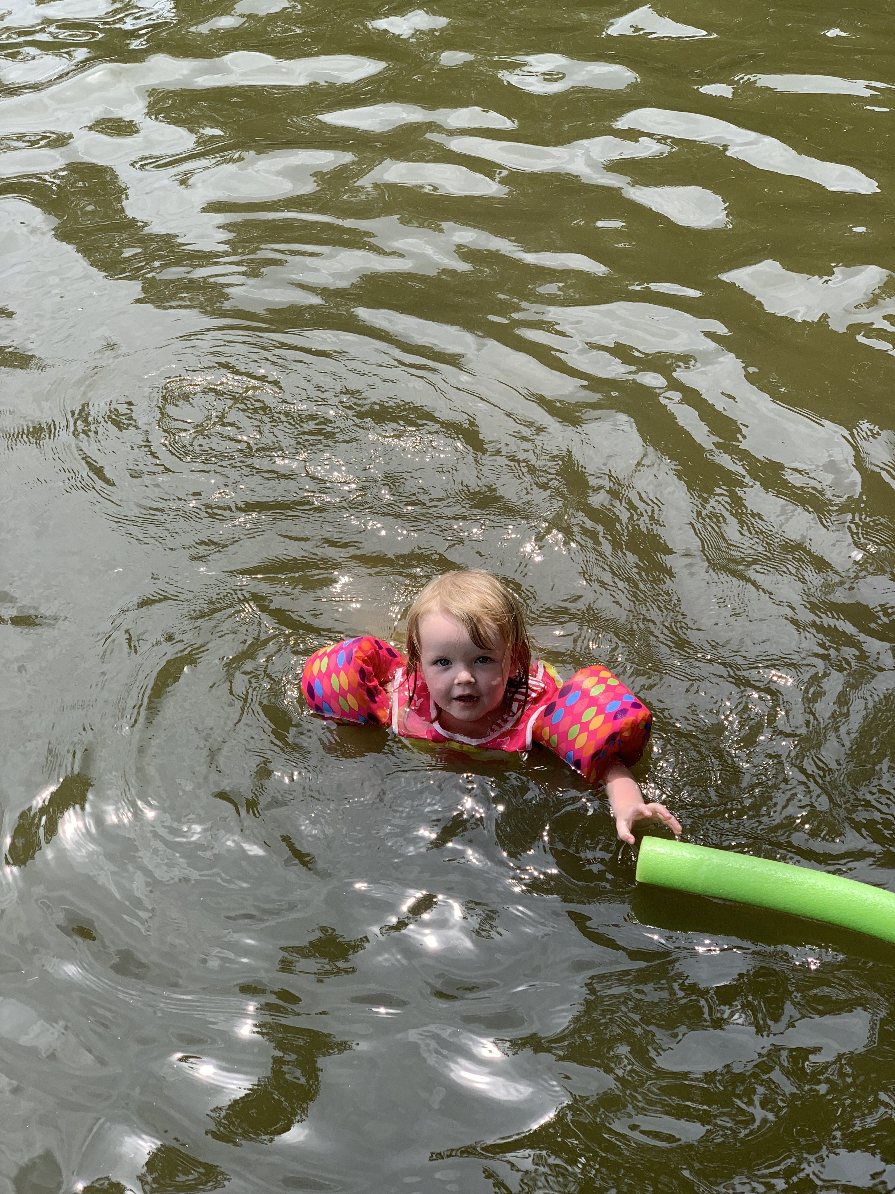 Toddler swimming in the lake