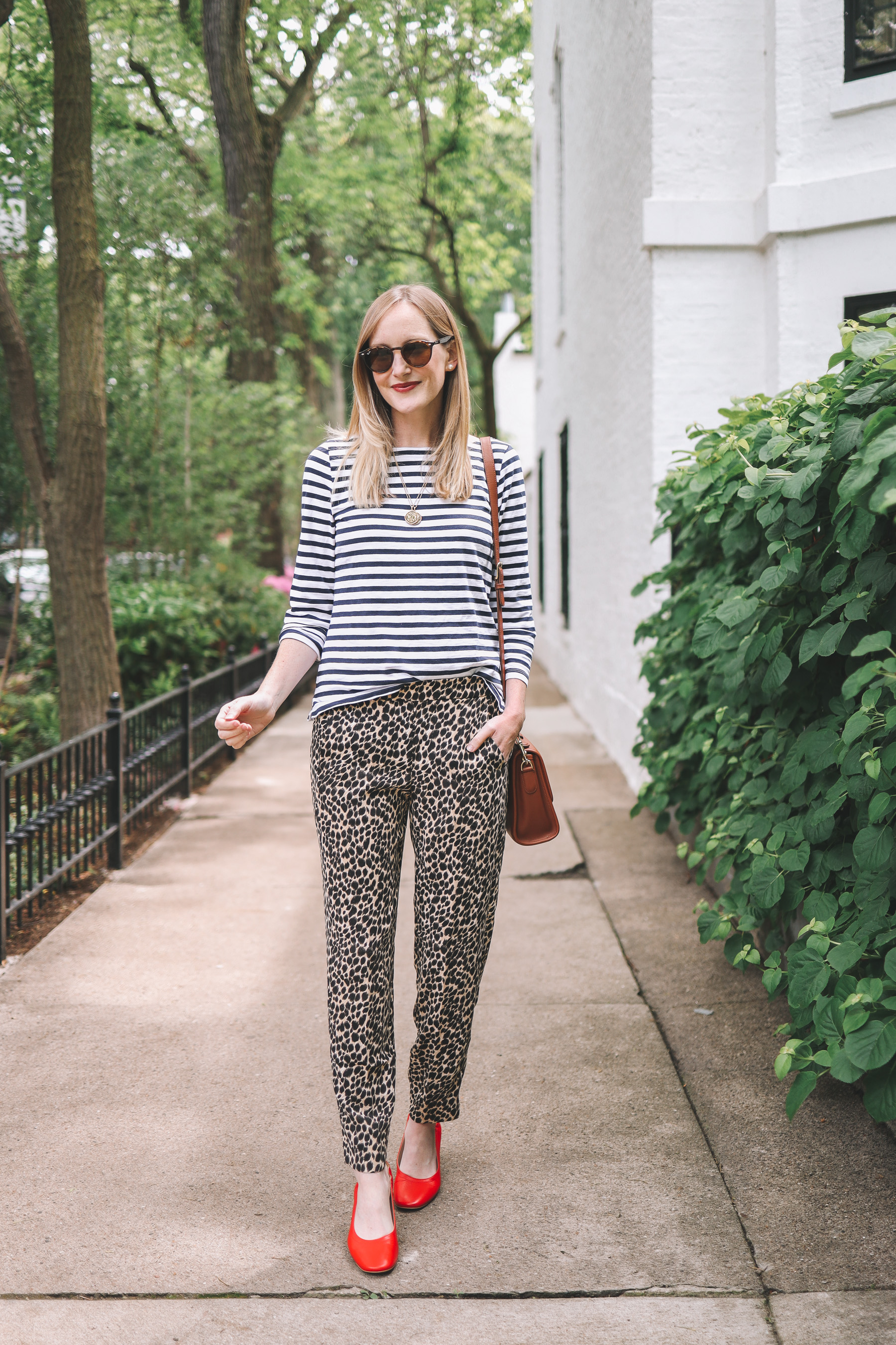 Kelly Larkin's outfit details: J.Crew Factory Pull-On Leopard Jamie Pants / Everlane Day Heels / J.Crew Striped Tee / Crossbody / Maxi-Cosi Carrier