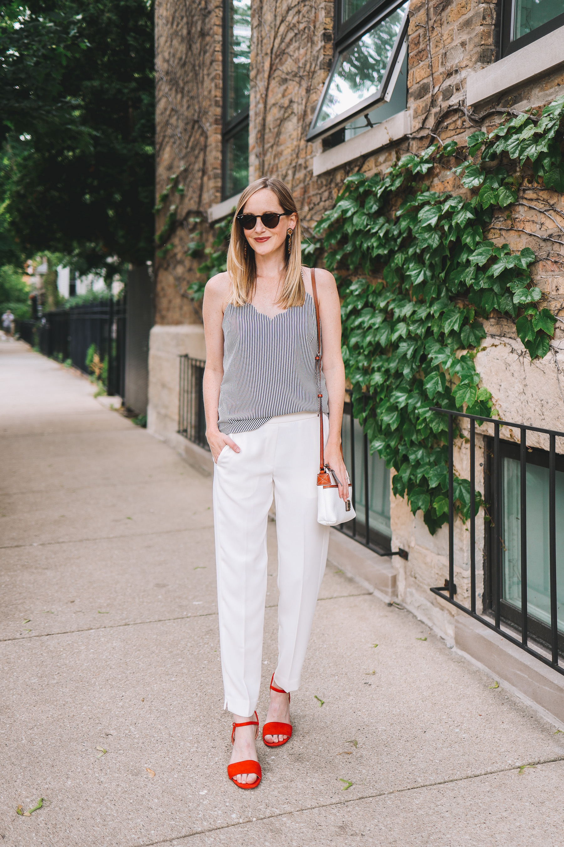 Kelly's outfit details: J.Crew Factory Scalloped Camisole / Pull-On Dress Pants / Red Sandals / Dooney & Bourke Bag / Lisi Lerch Earrings / Ray-Ban Sunglasses