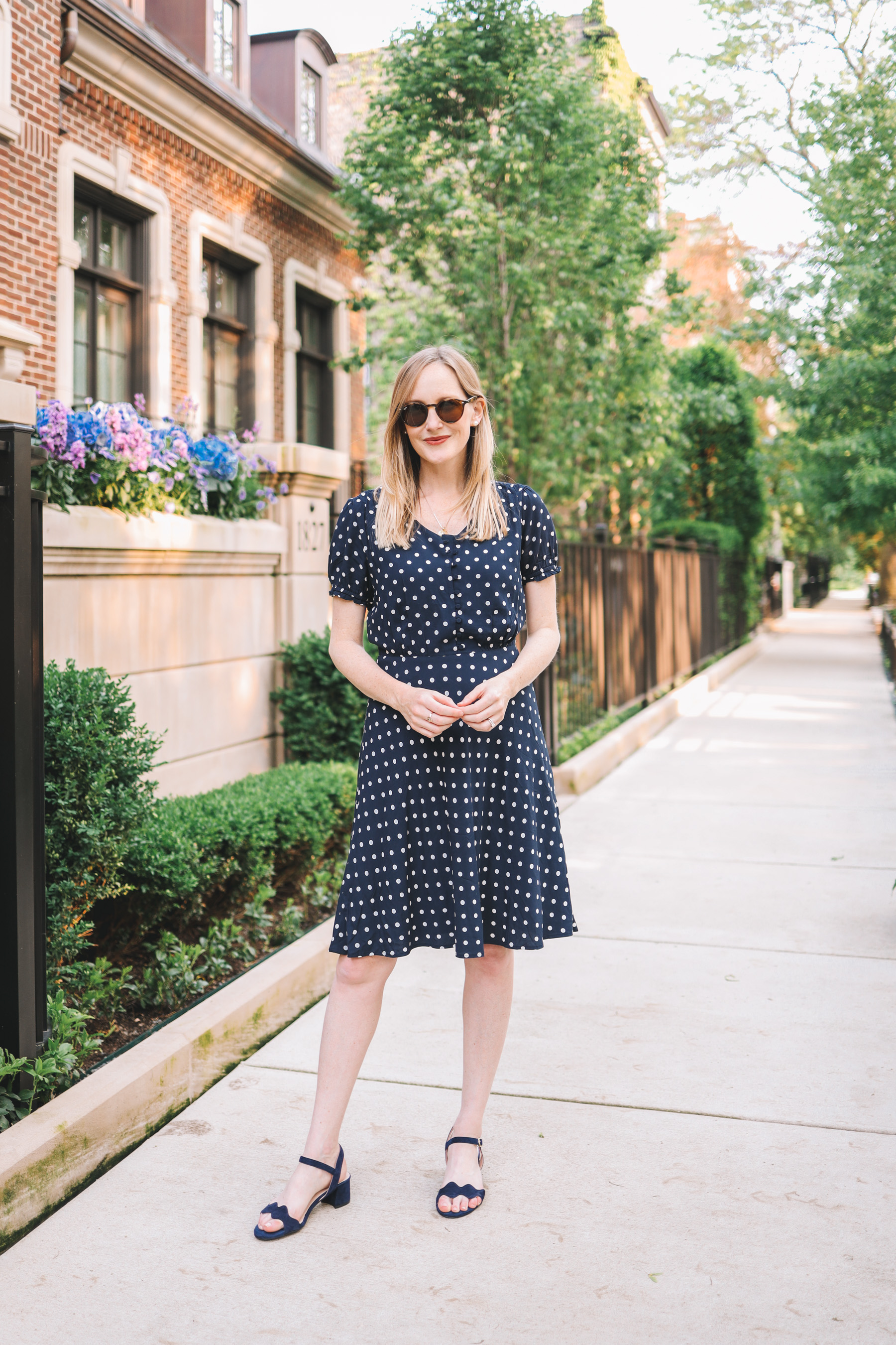Kelly Larkin's outfit details: Navy Polka Dot Dress / Patricia Green Scalloped Sandals / Stampled Initial Necklace 