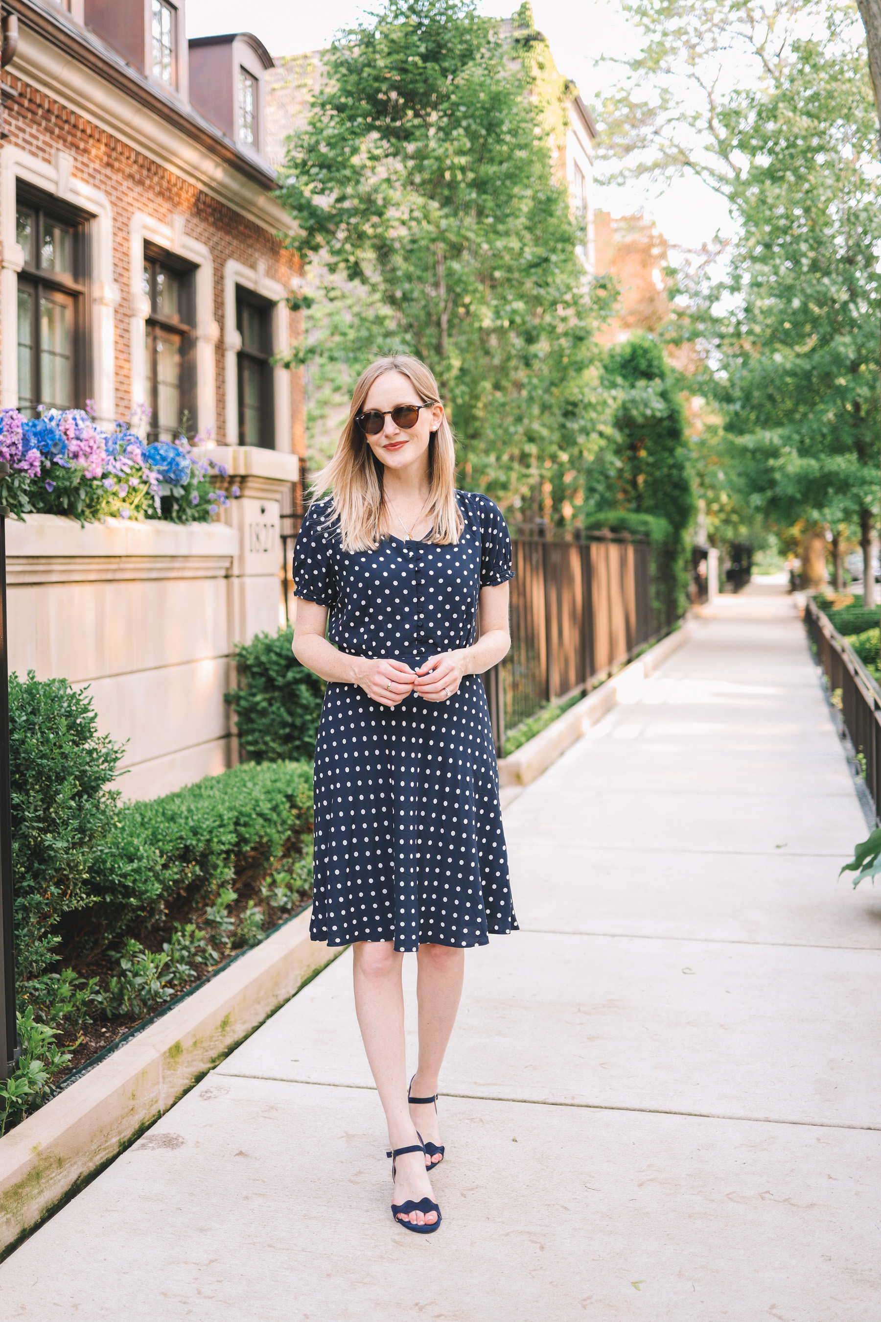 Kelly Larkin's outfit details: Navy Polka Dot Dress / Patricia Green Scalloped Sandals / Stampled Initial Necklace 