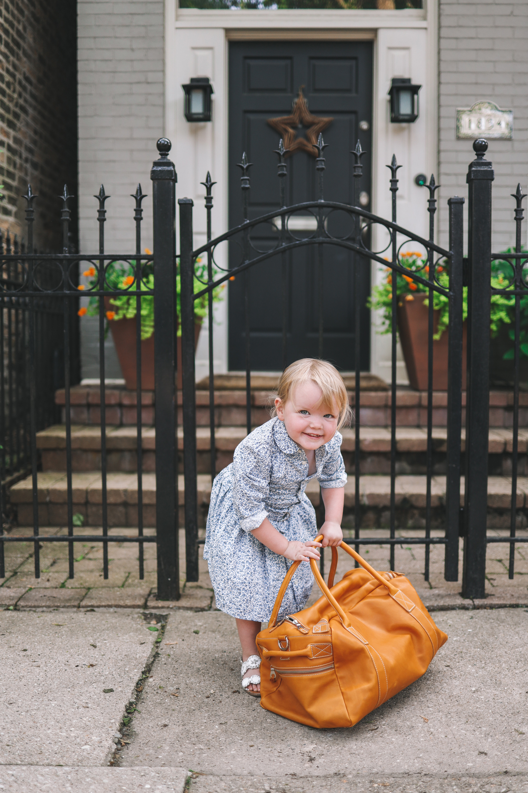 Emma is holding a Leather Overnight Bag from Mark and Graham