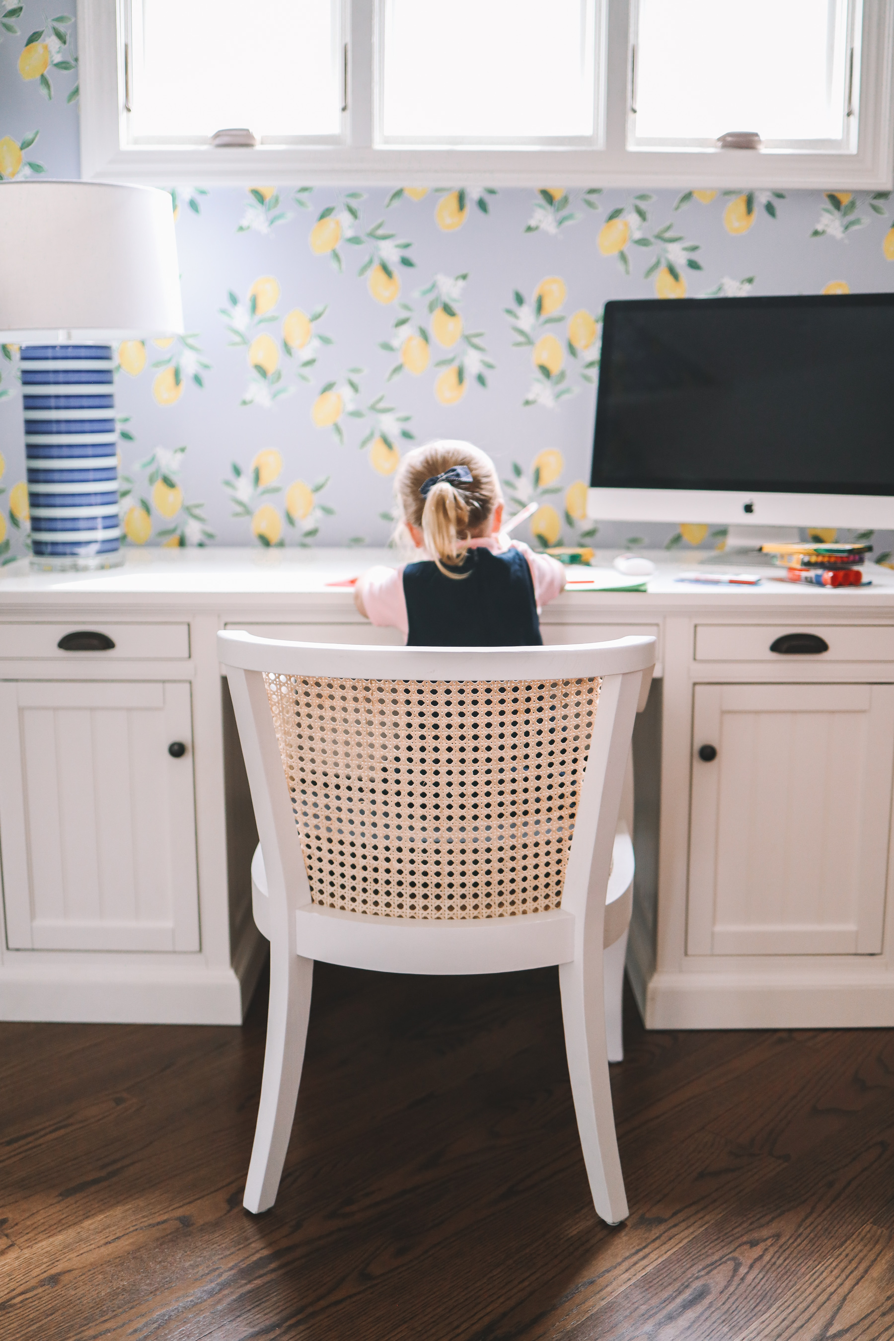 a little girl at a desk