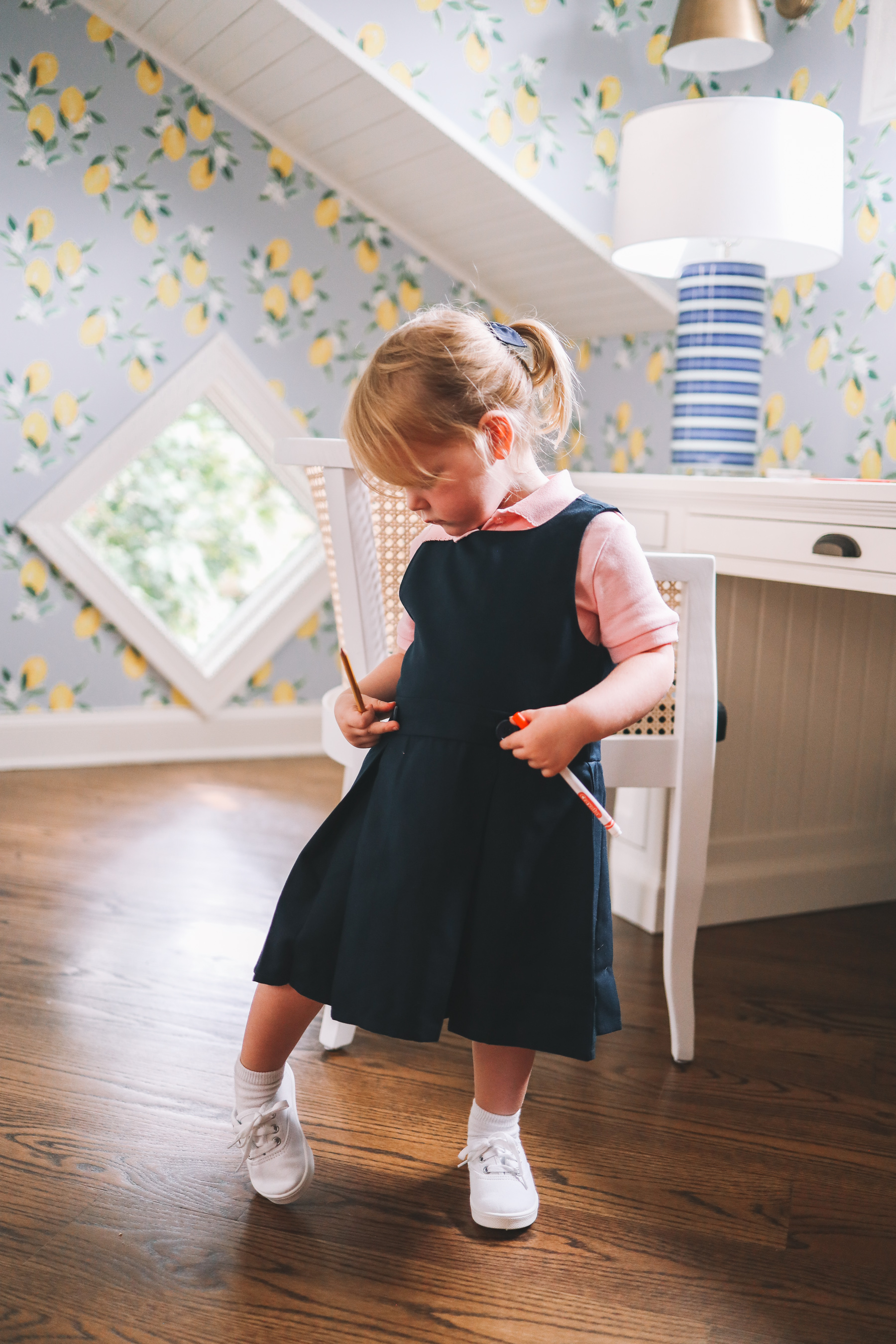 this little girl is looking at her pockets