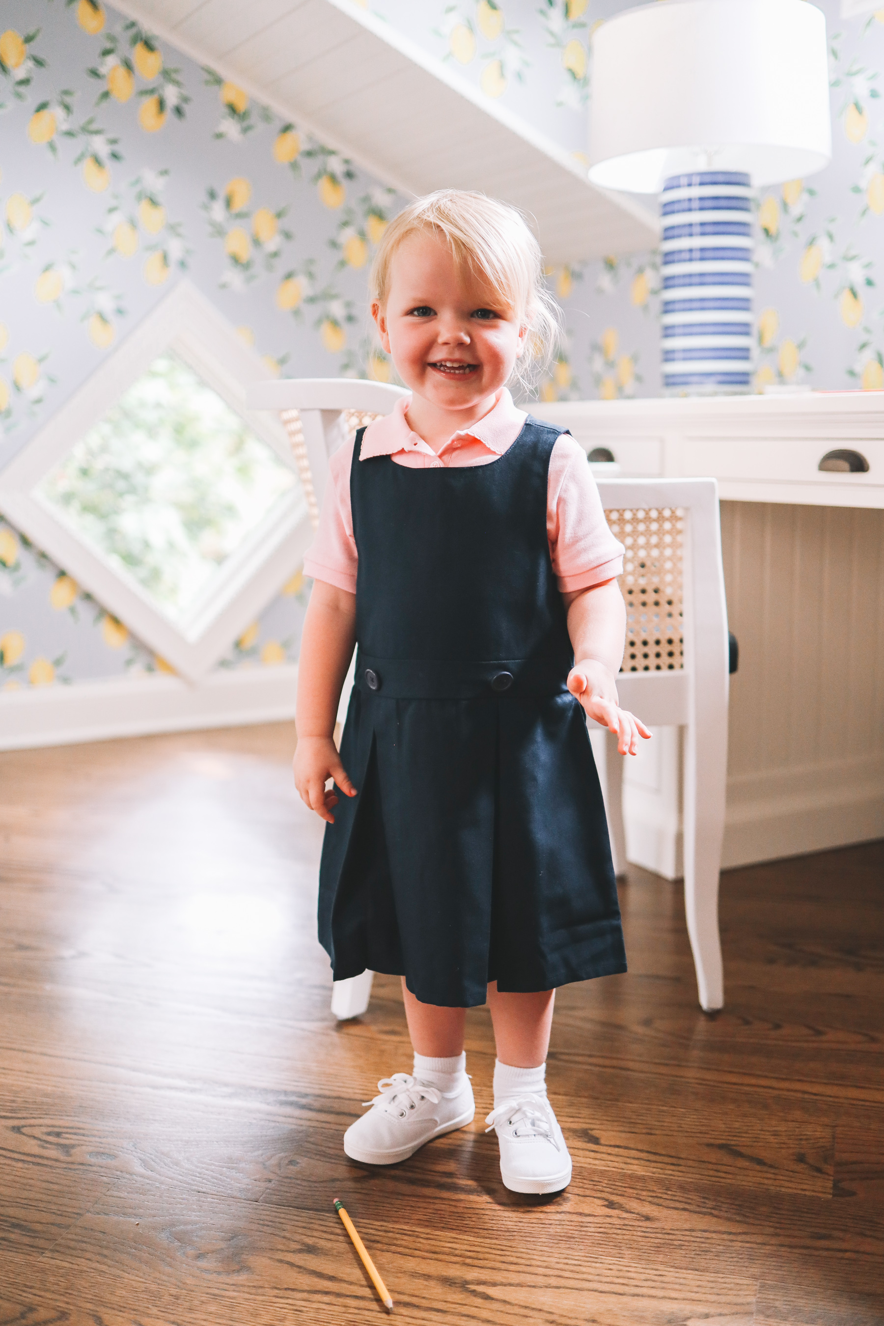 this little girl is all smiles on her way to school