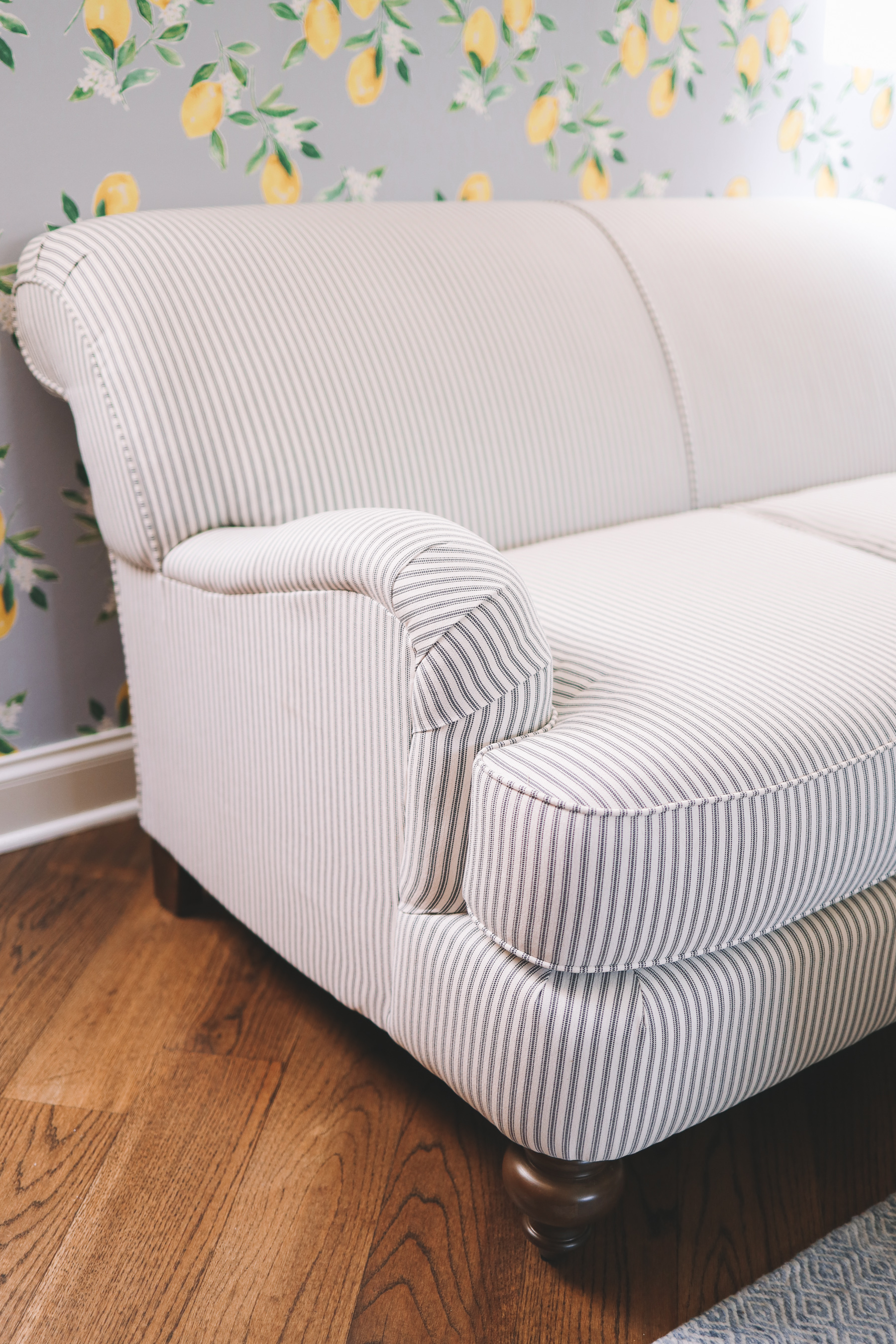 lemon wallpaper contrasting pinstripes on the loveseat