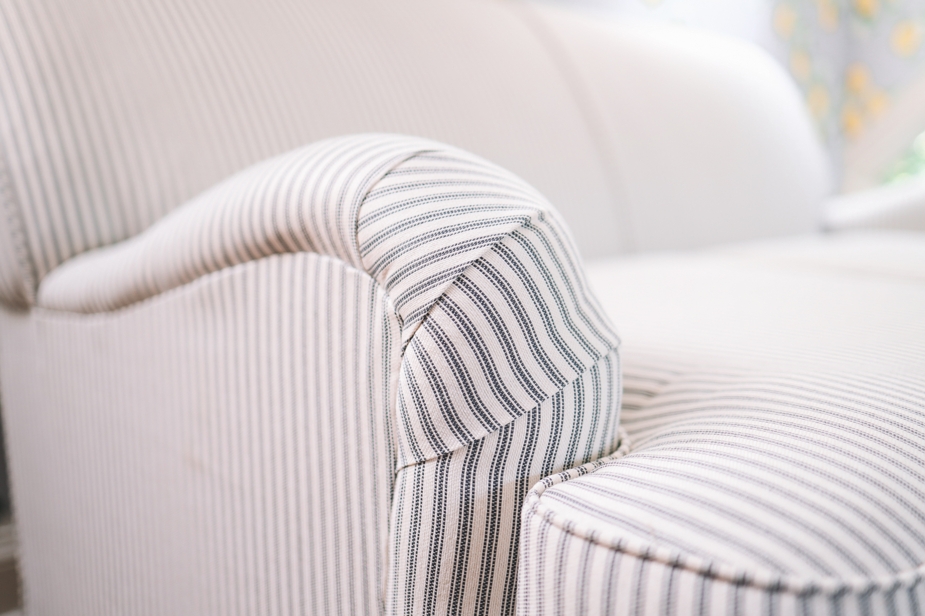 Up close shot of the custom striped loveseat, prices ranging from just under $600 to more, depending on customization 