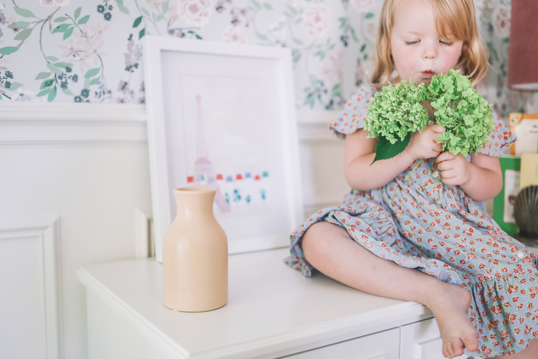 green leaves and a white picture frame with floral home wallpaper