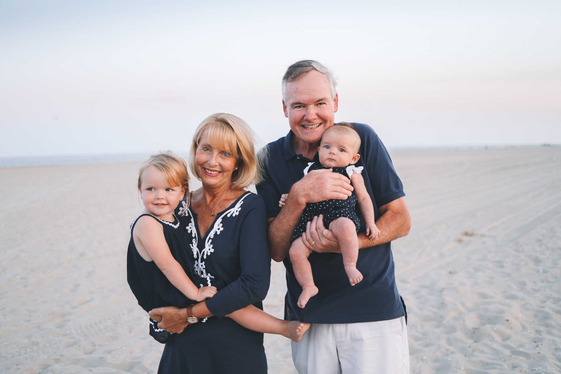 grandparents smile for family Christmas card photos