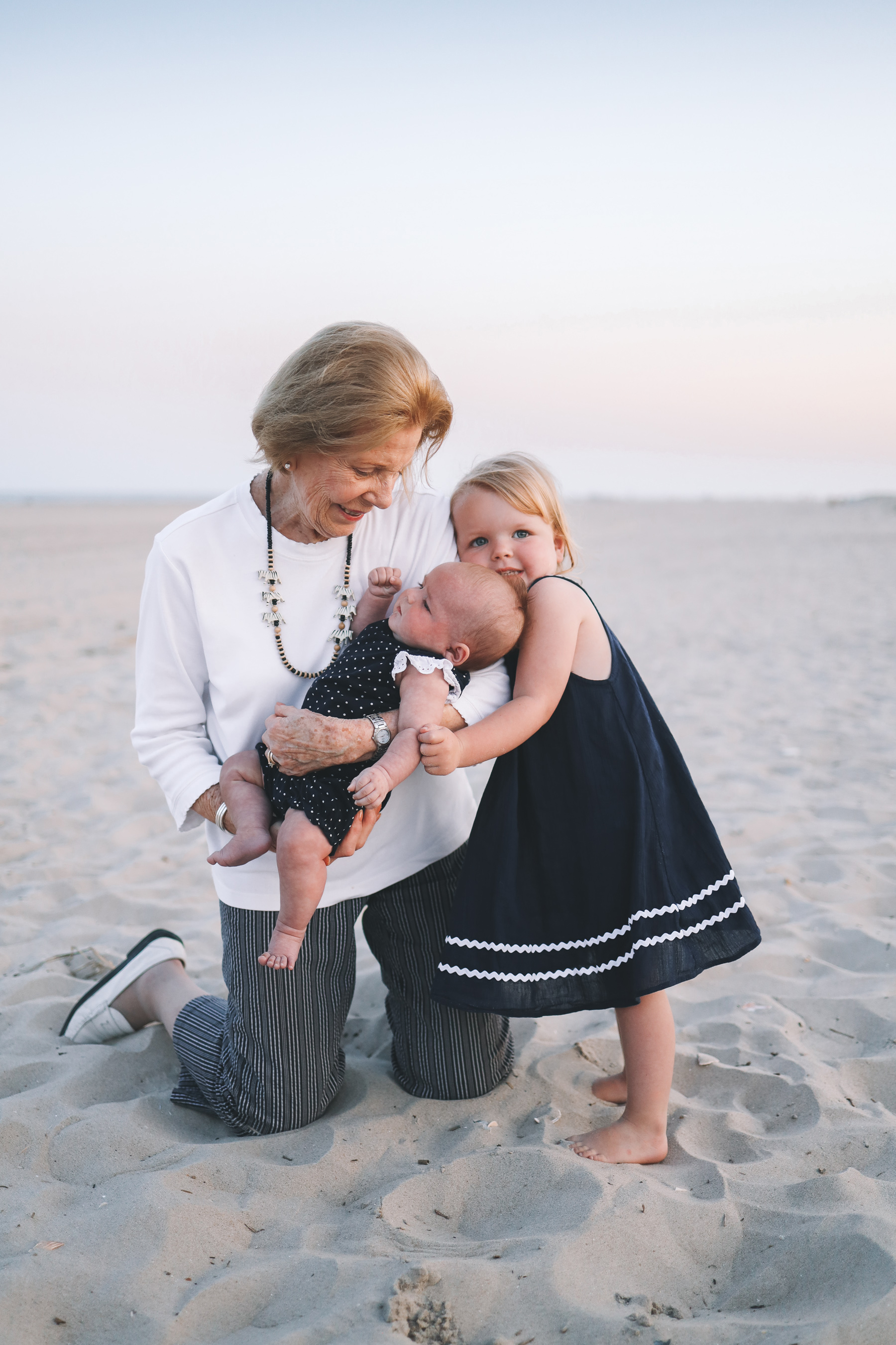 grandma holds babies for christmas