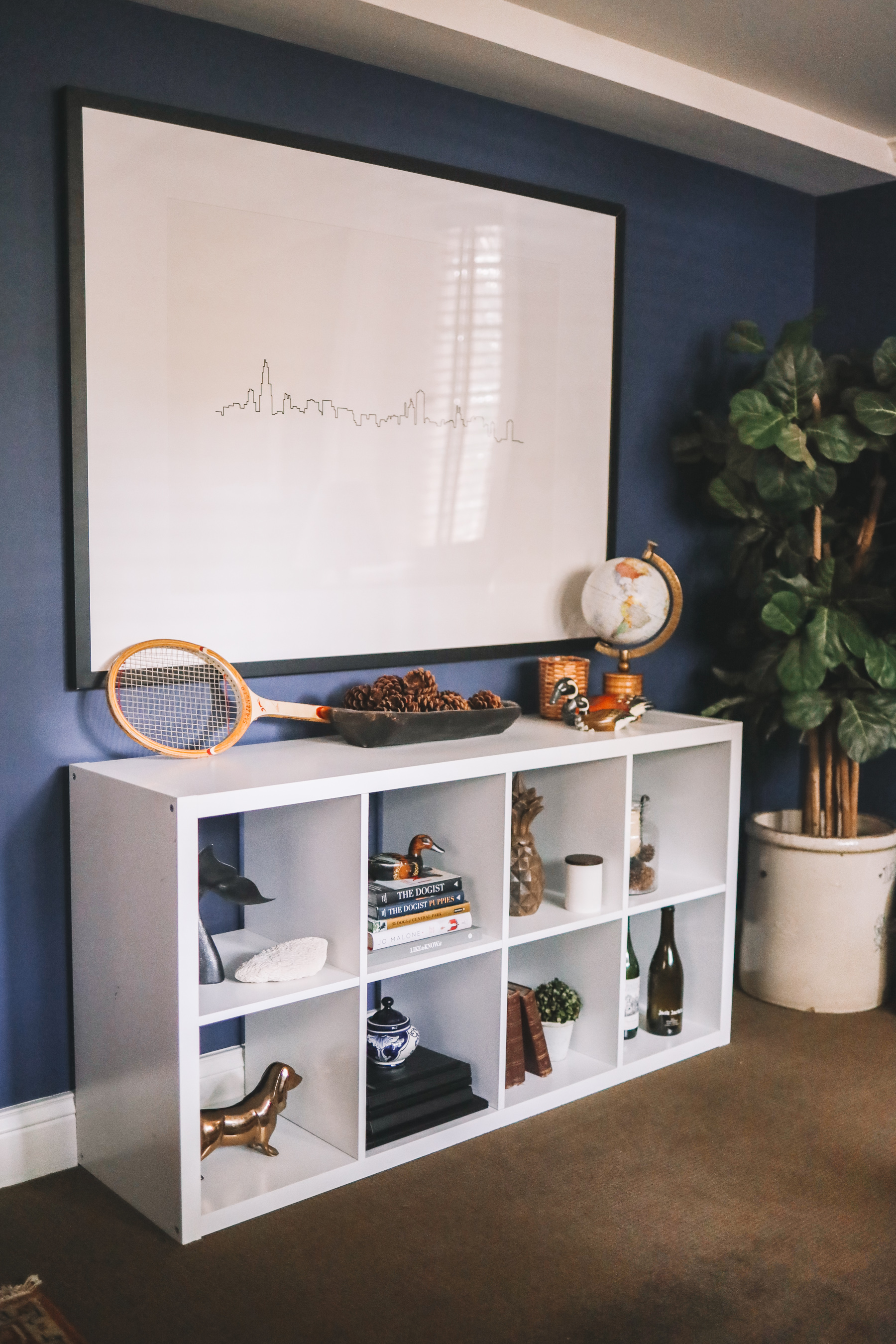 a navy blue office and a skyline painting