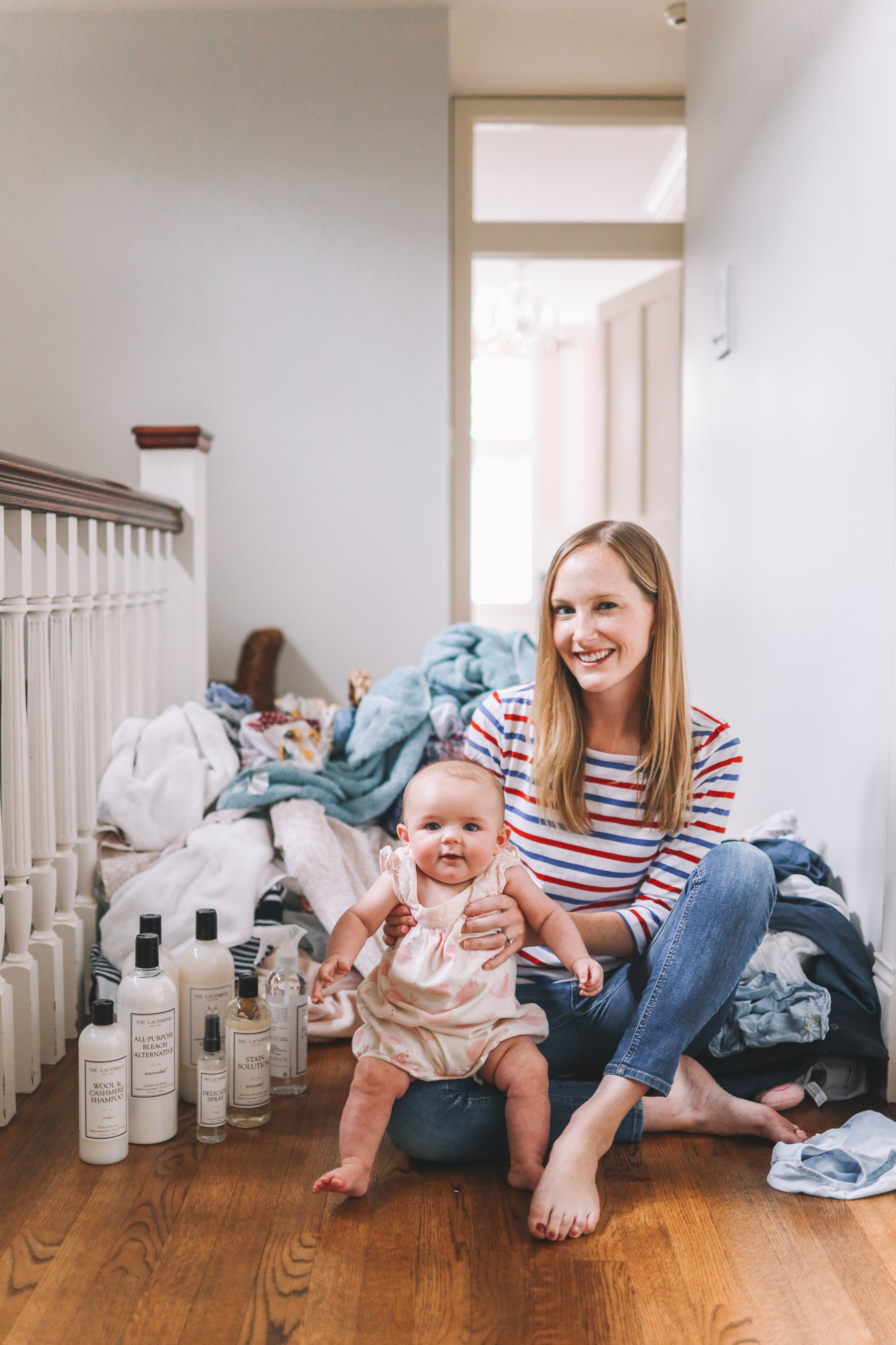 giveaway with laundress is promoted by this woman and her baby with laundry in the background