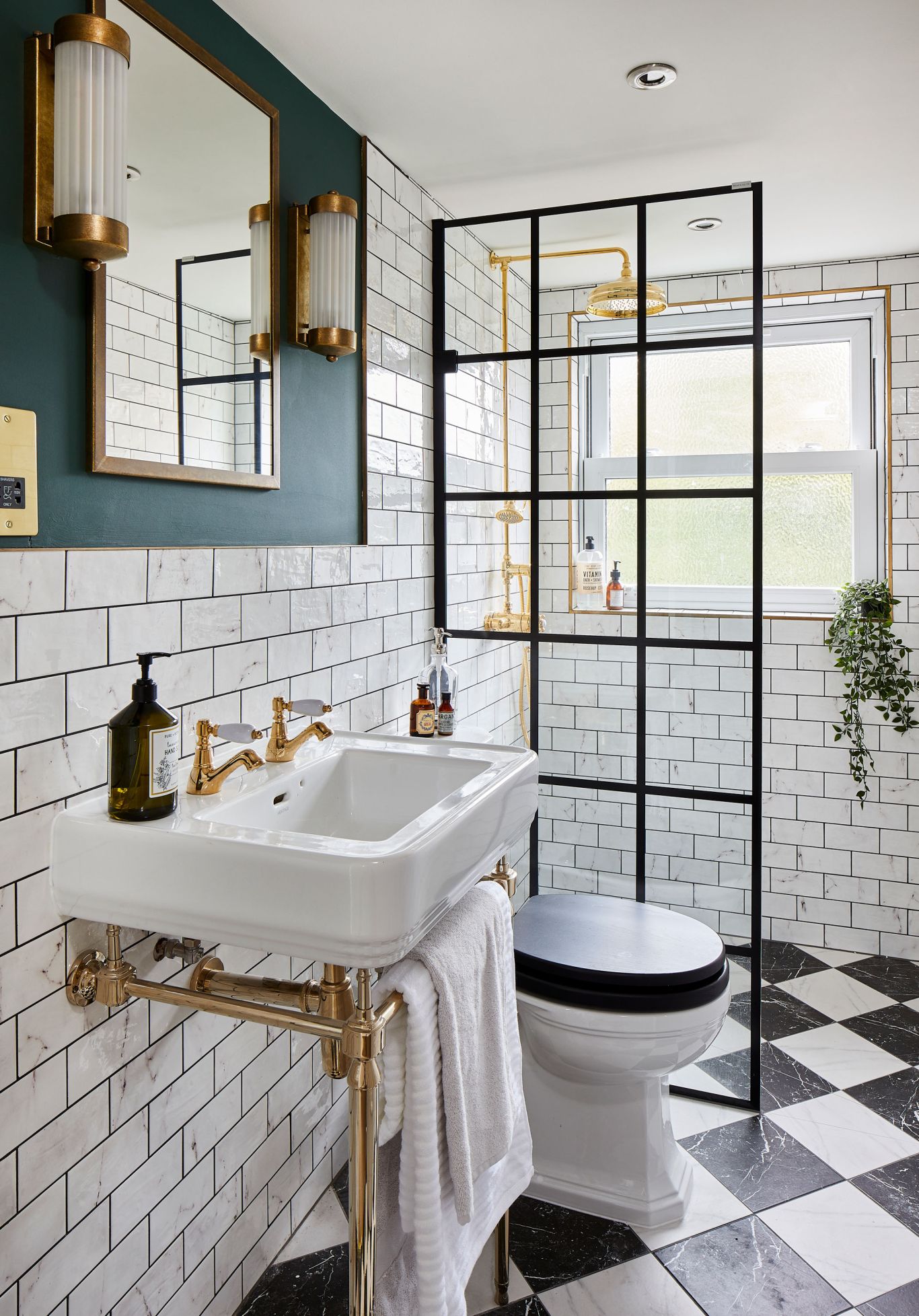 white and black bathroom // brass hardware // brass and glass