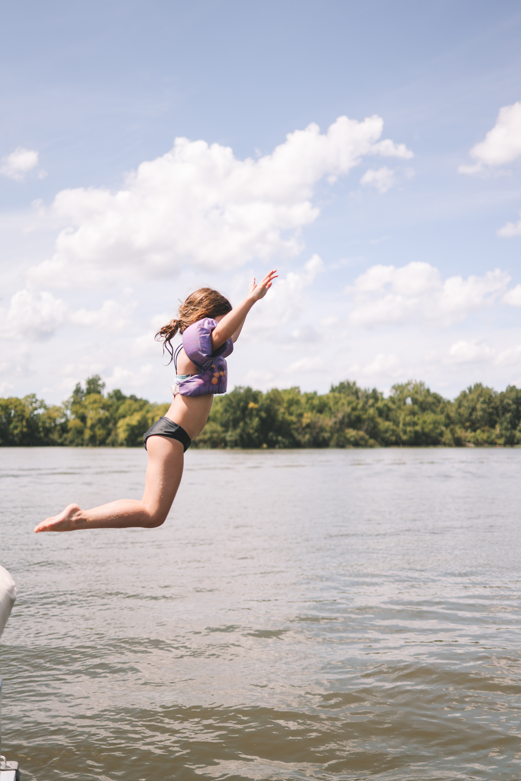 Kid jumping in Lake Bloomington