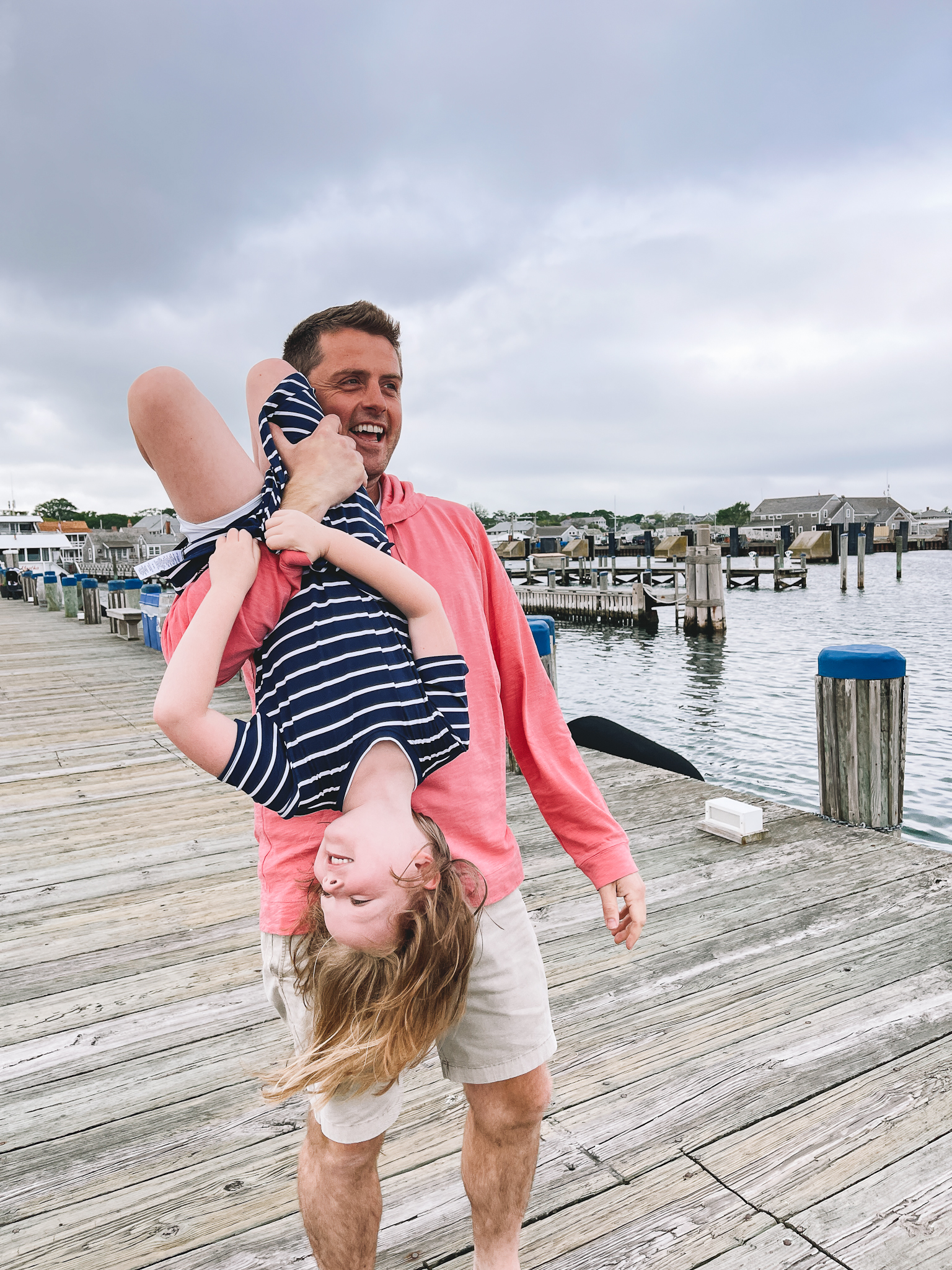 dad carrying daughter upside down