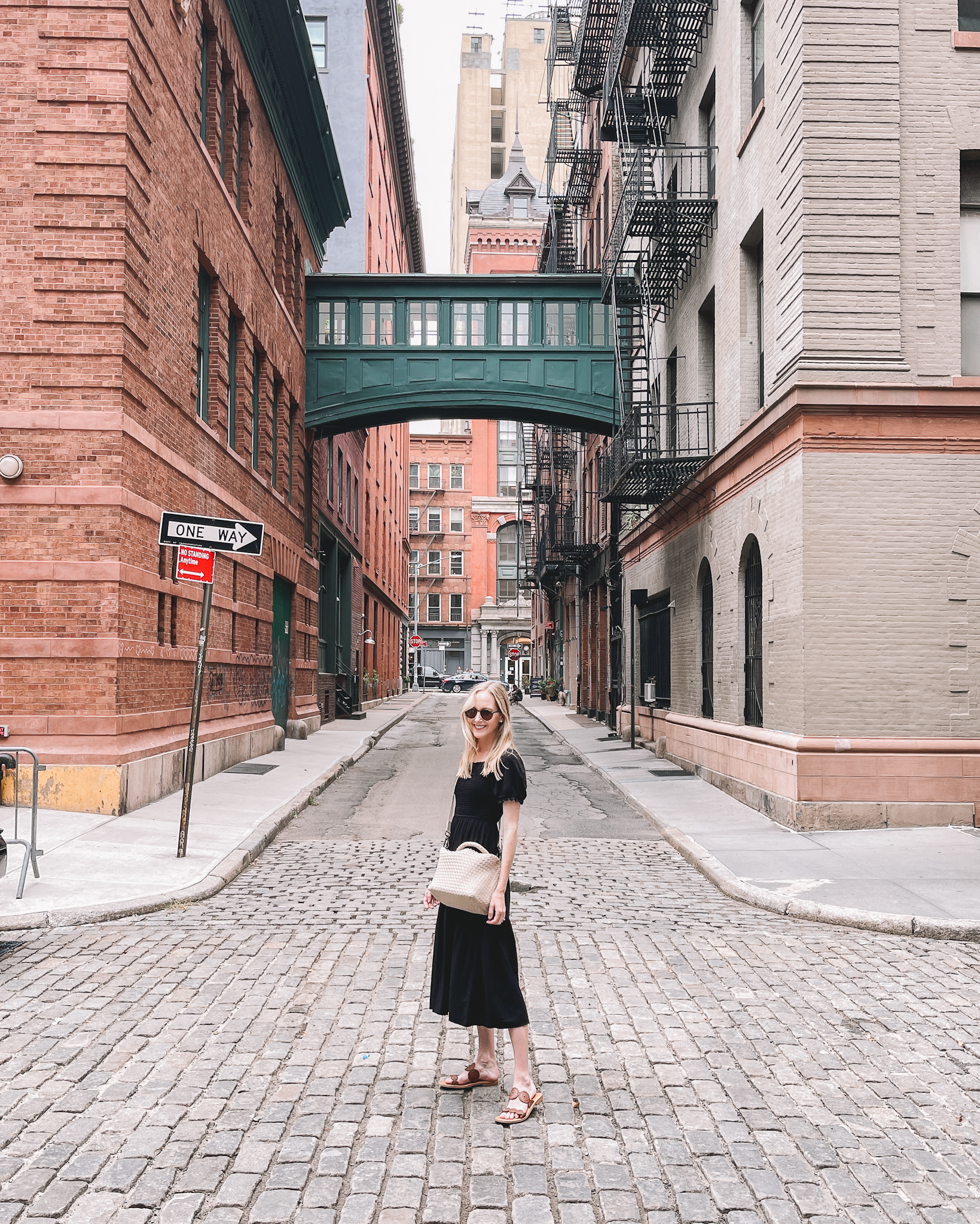 Premium Photo  A woman in a white t - shirt and black leggings stands in a  alley.