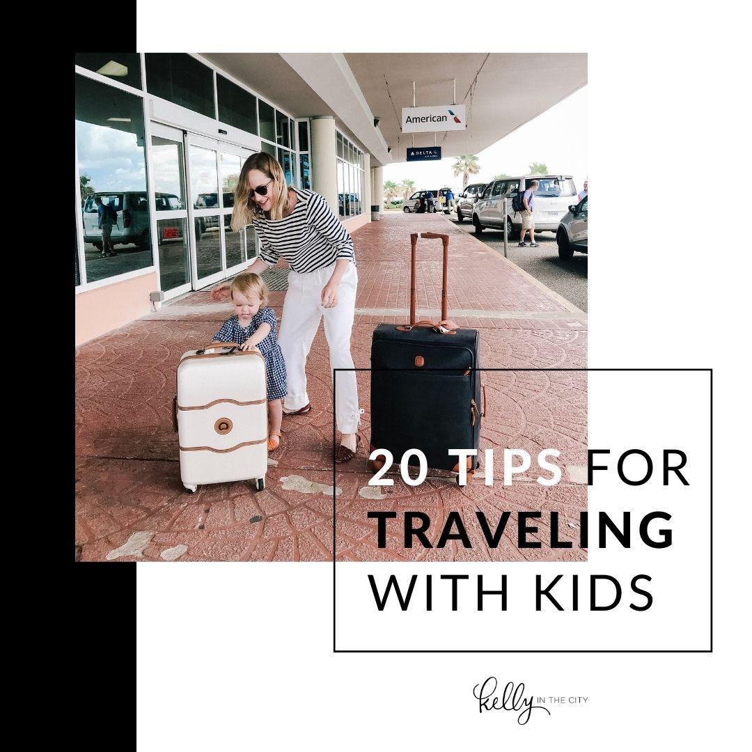 Kelly with two suitcases standing outside the ariport